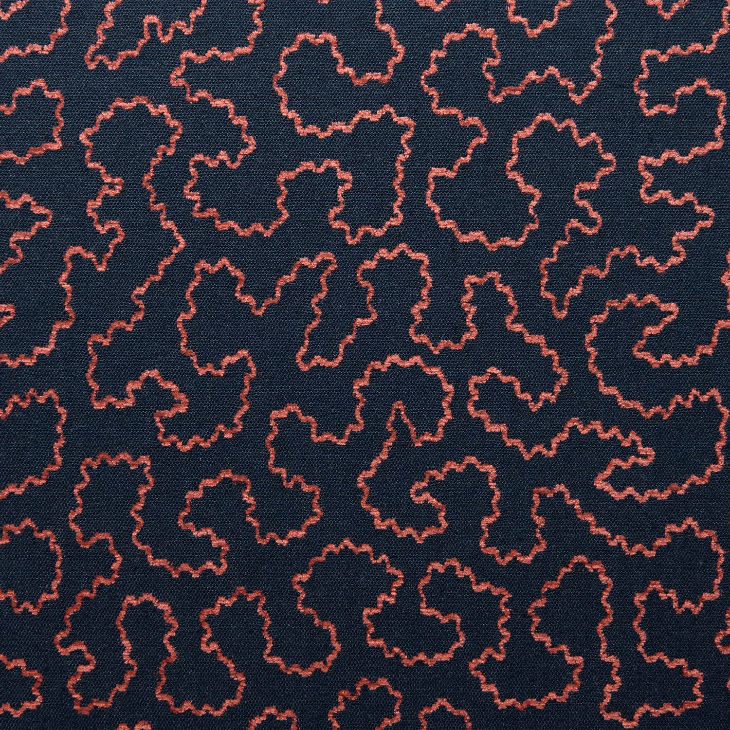 Deep navy woven fabric with small irregular coral-pink squiggle outlines