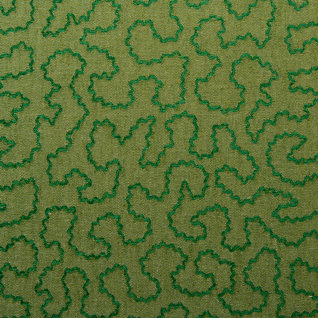 Olive woven fabric with emerald irregular outlines and fine textured ground