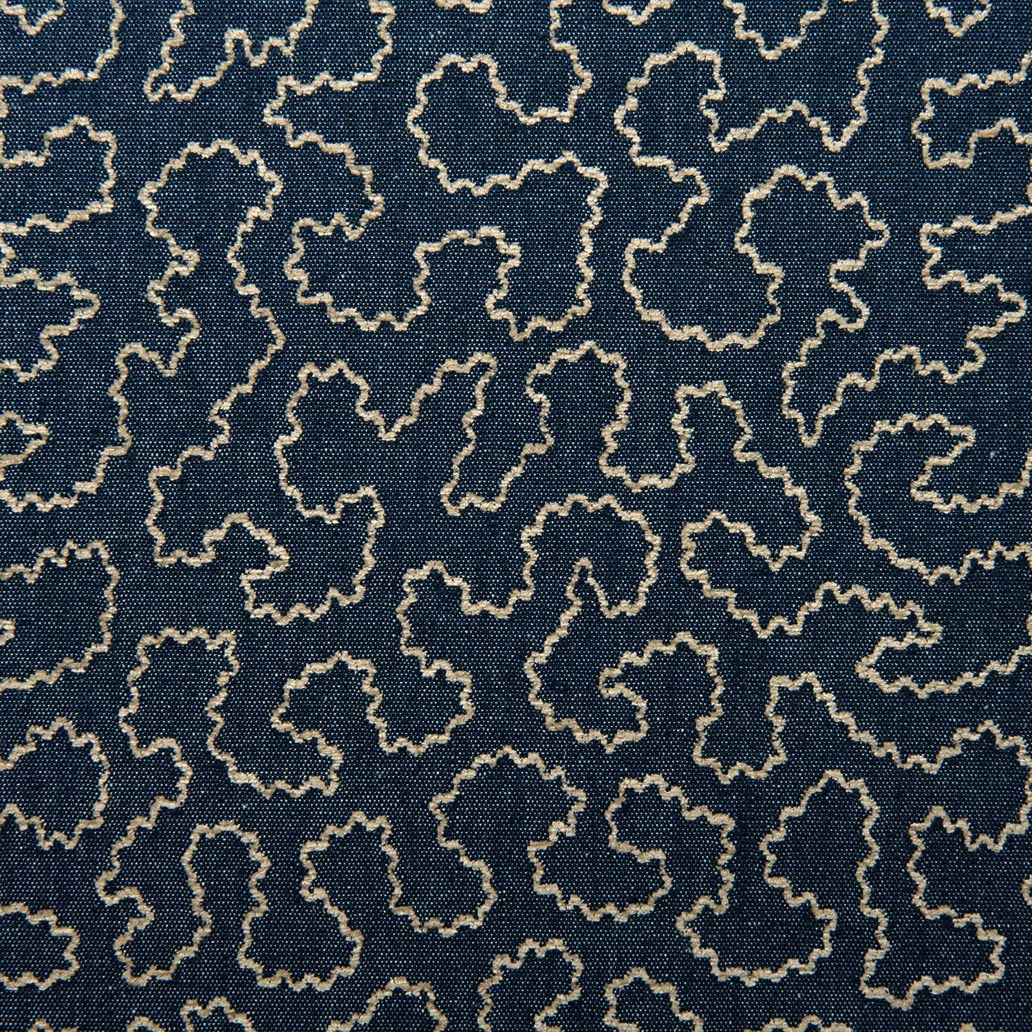 Deep indigo woven fabric with pale irregular outlined motifs in a small-scale pattern