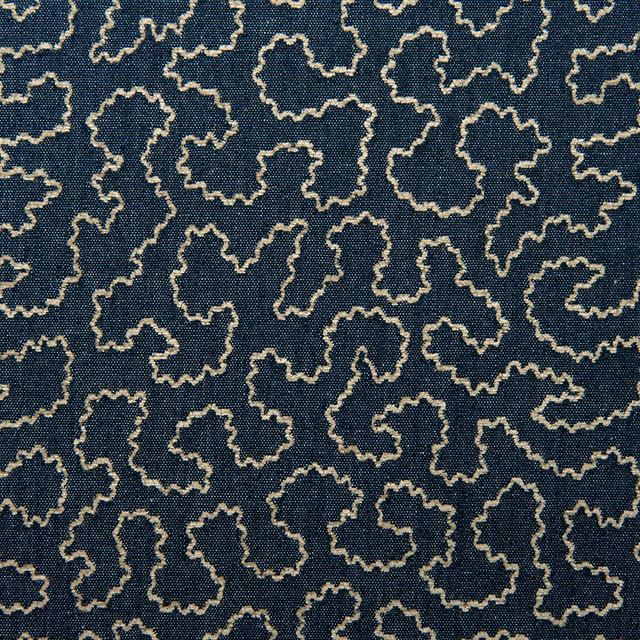 Deep indigo woven fabric with pale irregular outlined motifs in a small-scale pattern