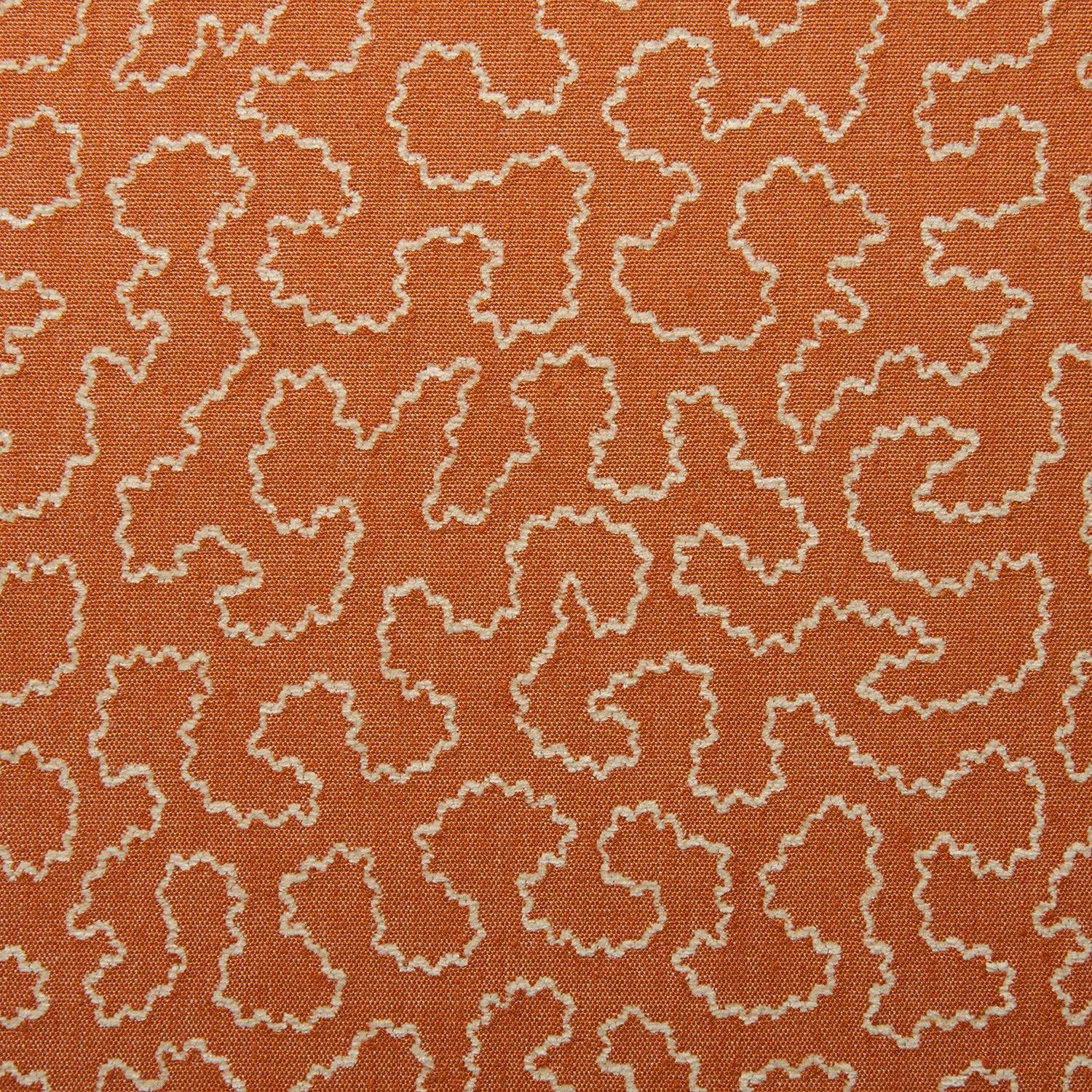 Terracotta woven fabric with cream irregular outlined motifs and visible textured weave