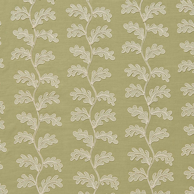 Sage green botanical fabric with pale trailing leaf motif on textured ground