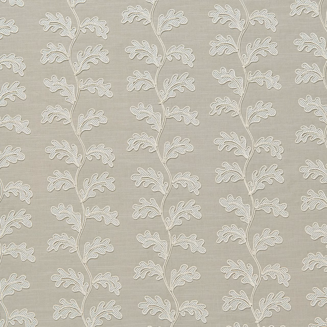 Pale dove grey woven fabric with raised trailing leaf motif