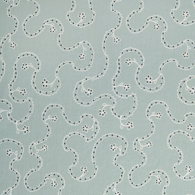 Pale mint green fabric with white scrolling embroidery-style pattern and dark dotted accents