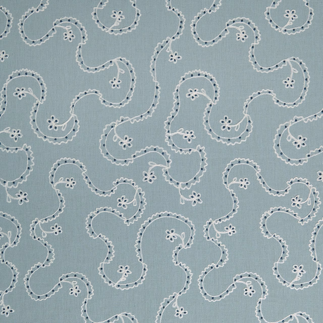 Powder-blue embroidered cushion fabric with scrolling vine motif and small floral details