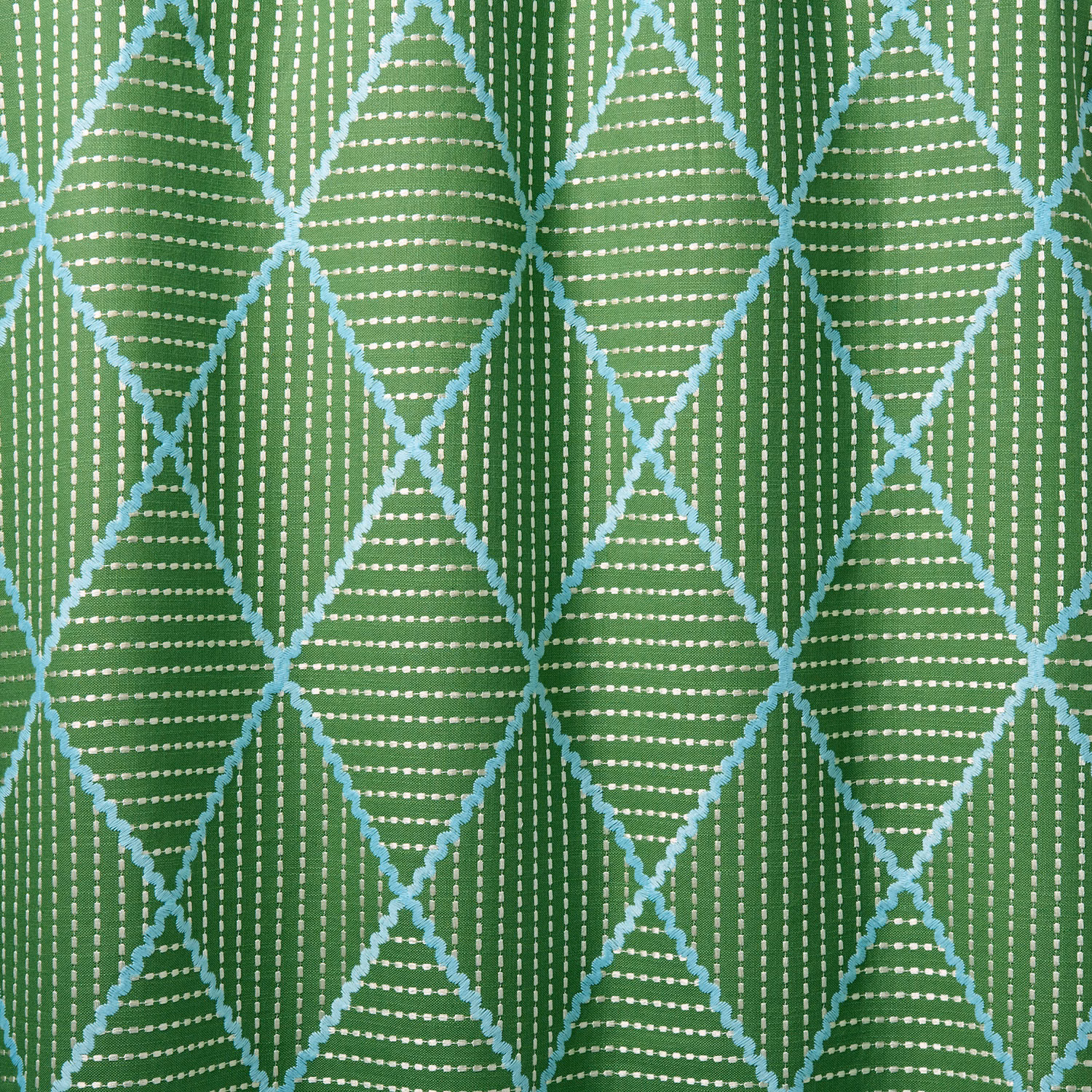 Green geometric woven fabric with turquoise diamond outlines and white dotted stripes