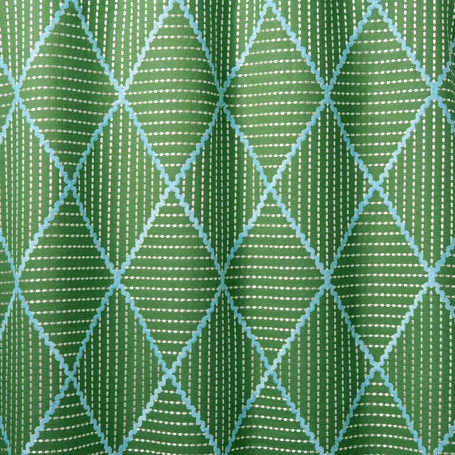 Green geometric woven fabric with turquoise diamond outlines and white dotted stripes