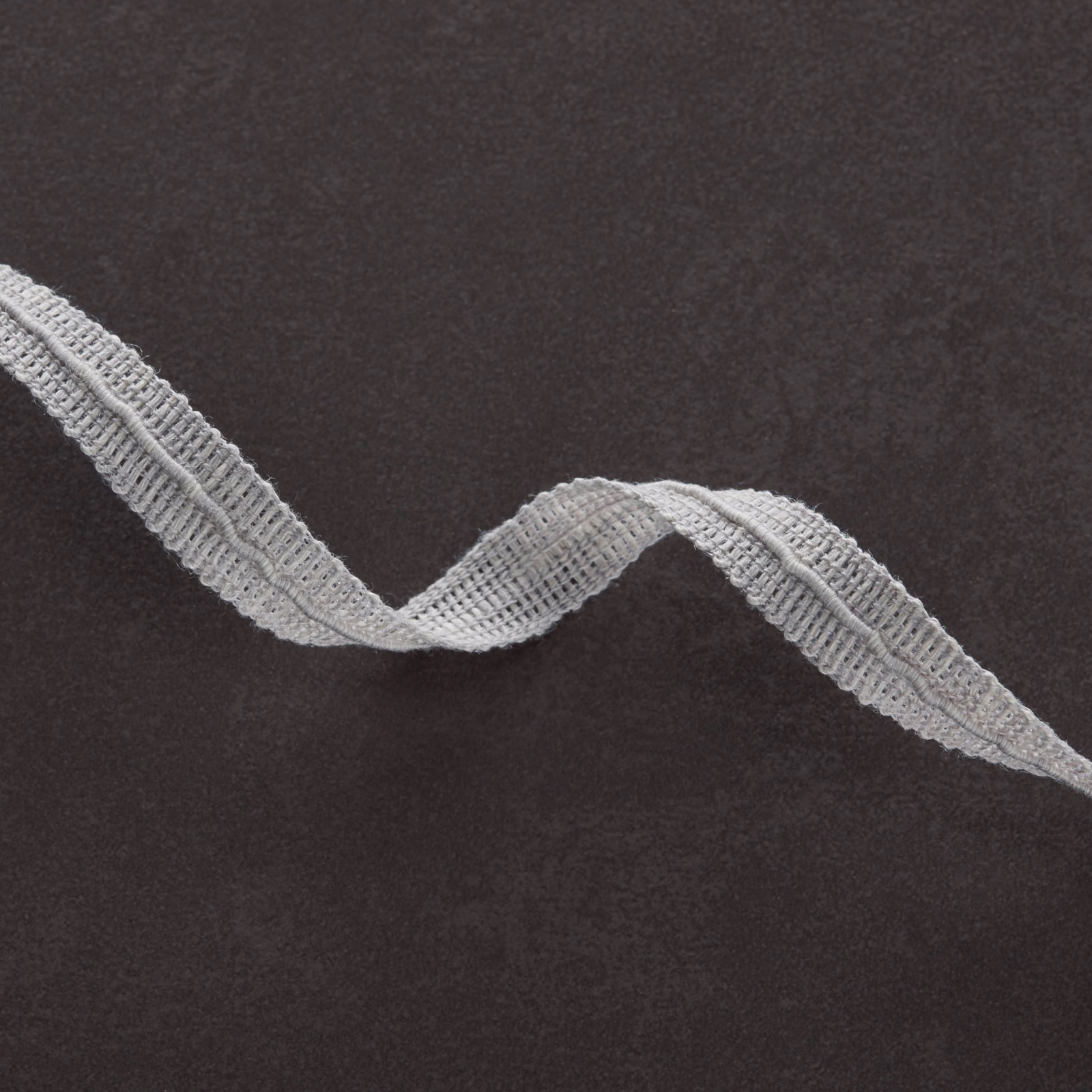 Charcoal fabric with a raised dove-grey wave ribbon and ridged texture