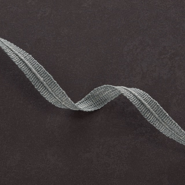 Charcoal-brown textile with a raised blue-grey serpentine woven band