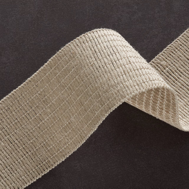 Warm natural beige ribbed textile with fine cross threads, folded to show its tactile texture