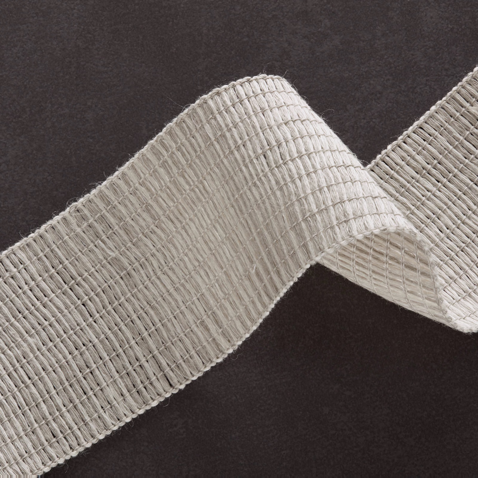 Pale silvery-grey woven fabric with raised ribs and an irregular grid texture