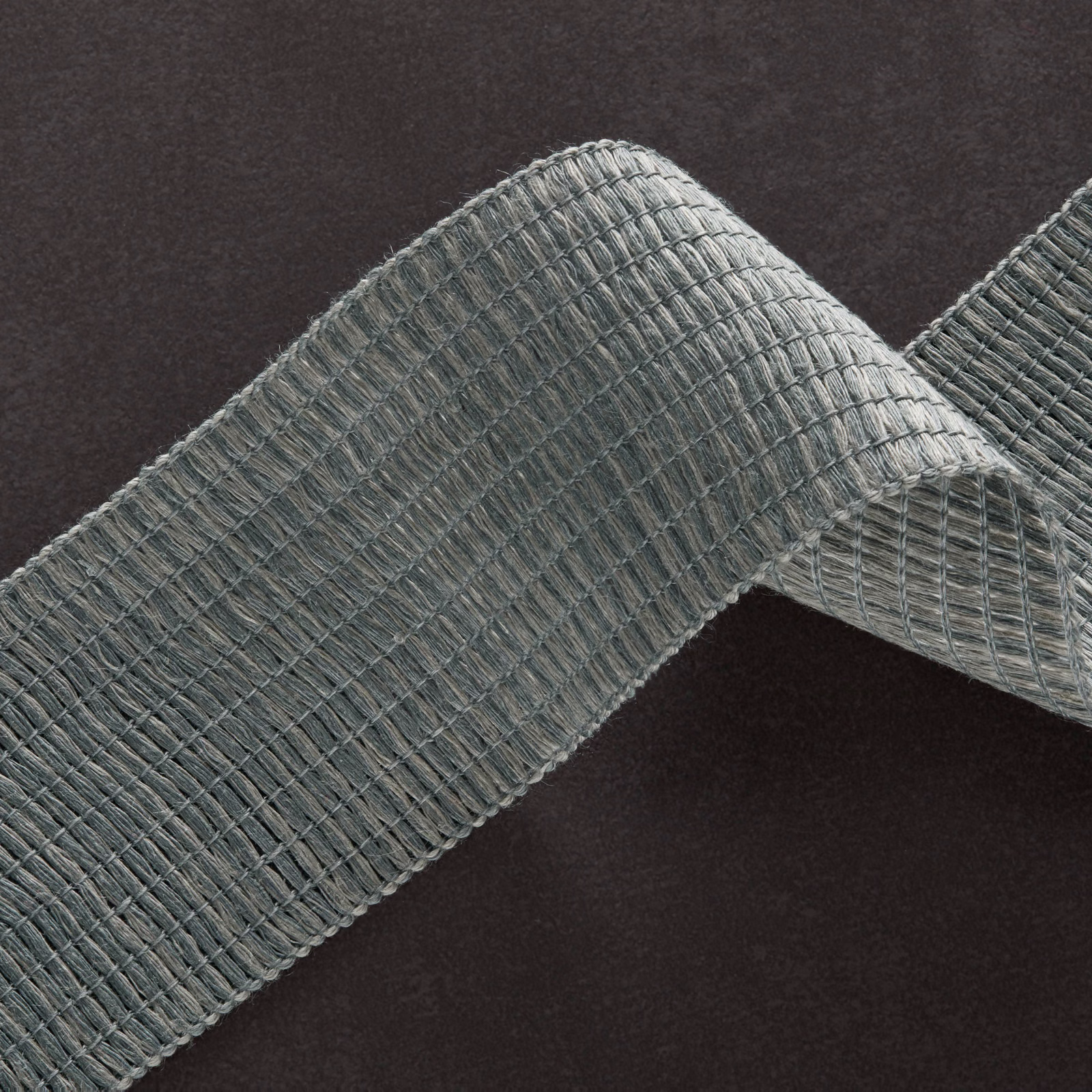 Cool blue-grey fabric swatch showing a tightly ribbed woven texture in a folded loop