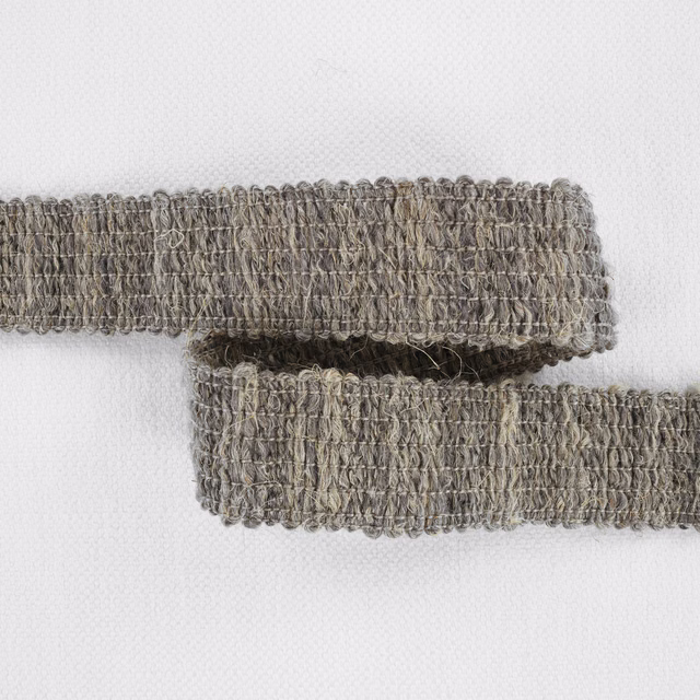 Close-up of taupe-grey Boulder fabric with dense irregular loops and darker threads