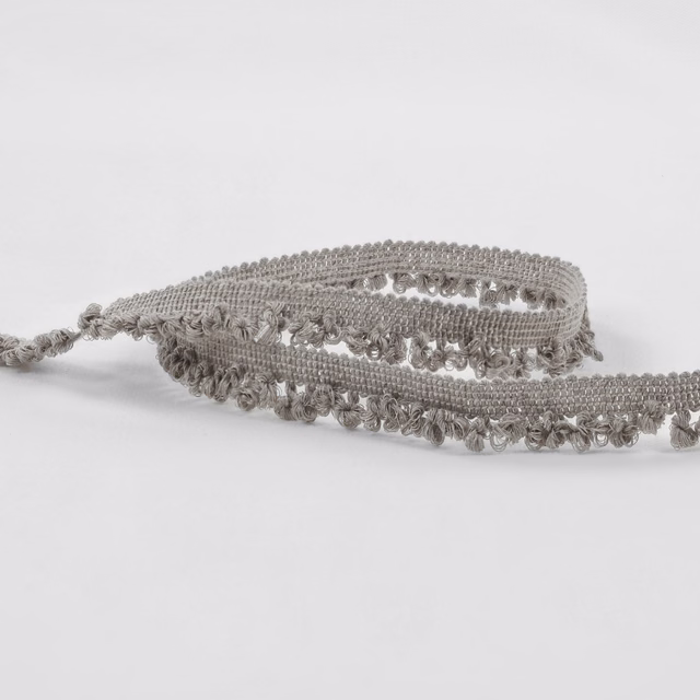Cool cement-grey boucle with raised loops and a softly fringed woven edge