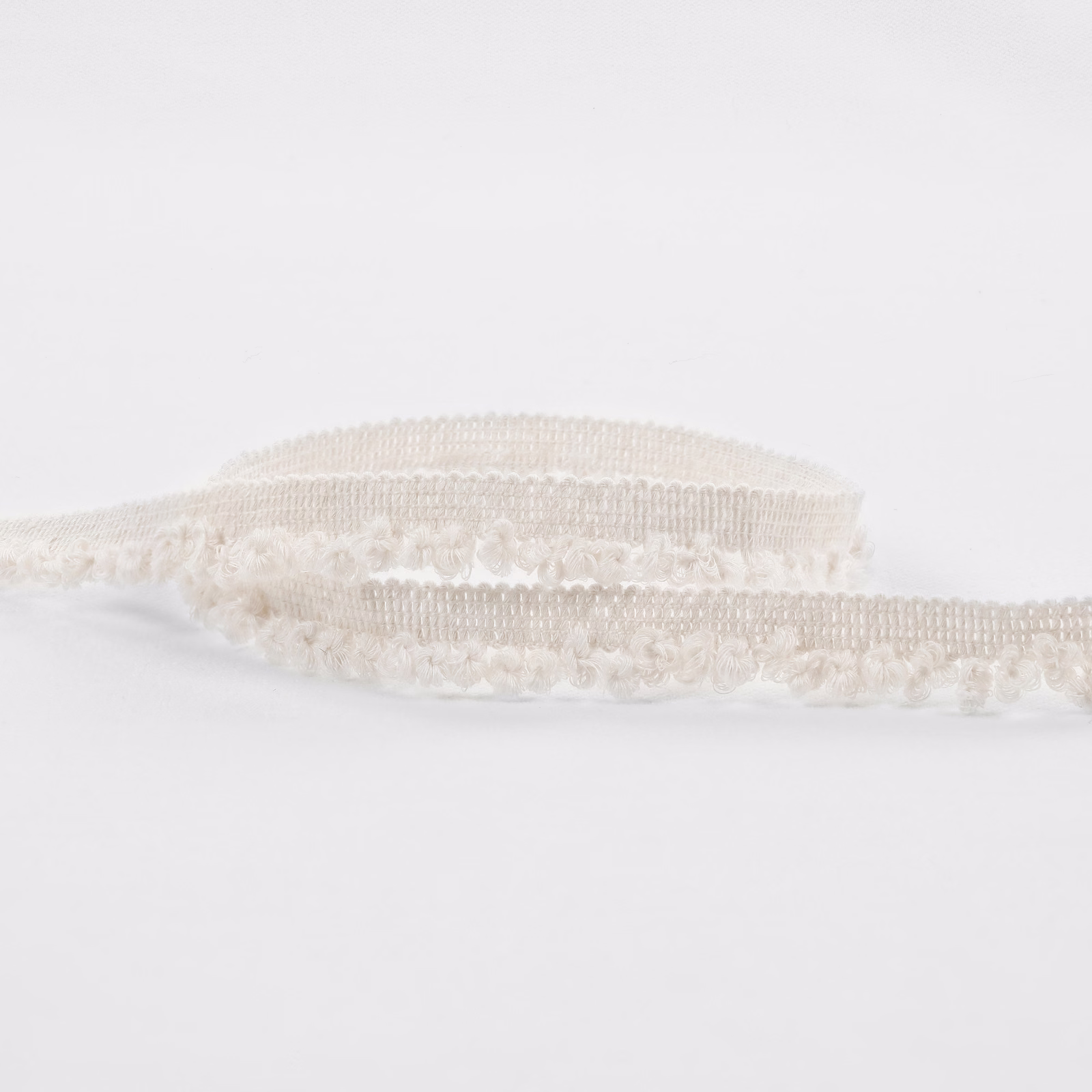 Warm ivory boucle with raised loops and softly banded texture