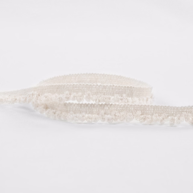 Warm ivory boucle with raised loops and softly banded texture