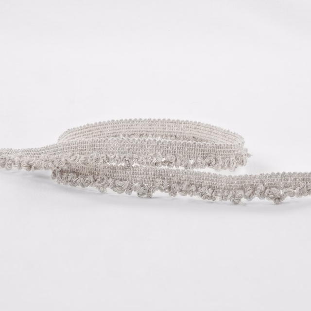 Pale greige boucle textile with raised loops and softly mottled silver-grey texture