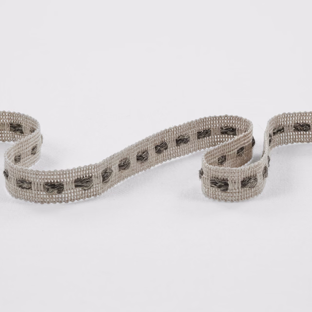 Warm grey woven trim with repeated charcoal stitched motifs and ribbed edges