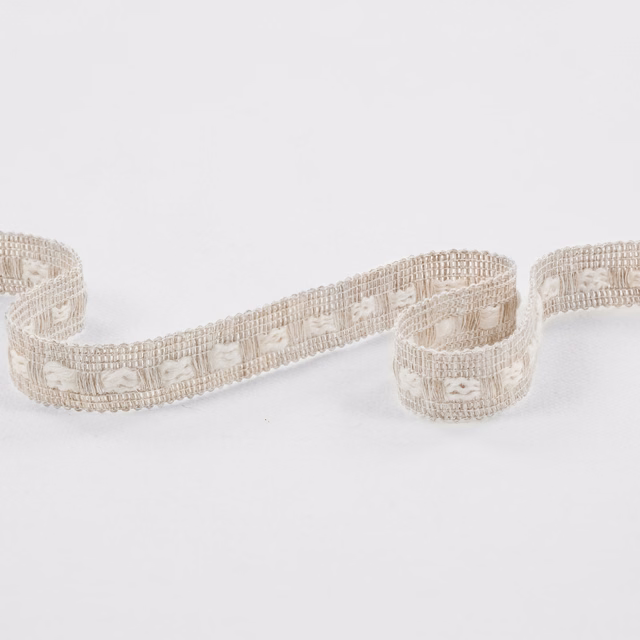 Ecru woven trim with raised loop motifs and ribbed edging