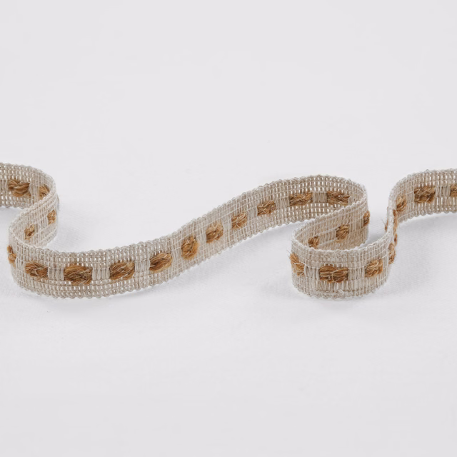 Pale oatmeal open-weave ribbon with repeated warm tan woven motifs