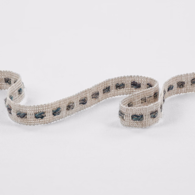 Oatmeal woven trim with repeating deep teal and charcoal motifs