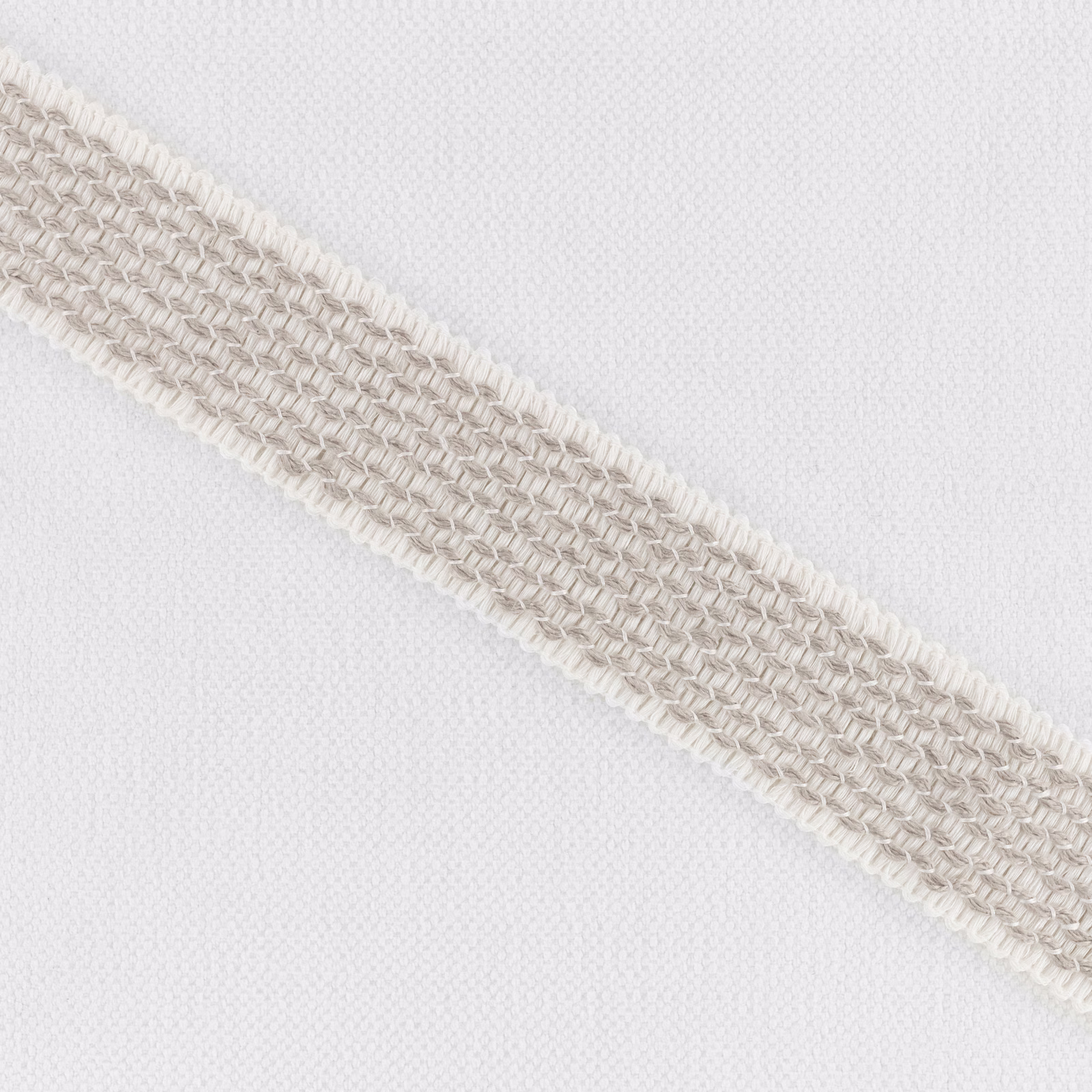 Pale ecru woven ground with a raised diagonal braided band
