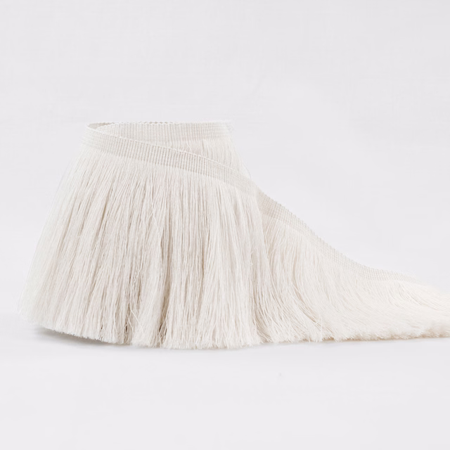 Warm ivory textile with a woven header and long, softly irregular fringe