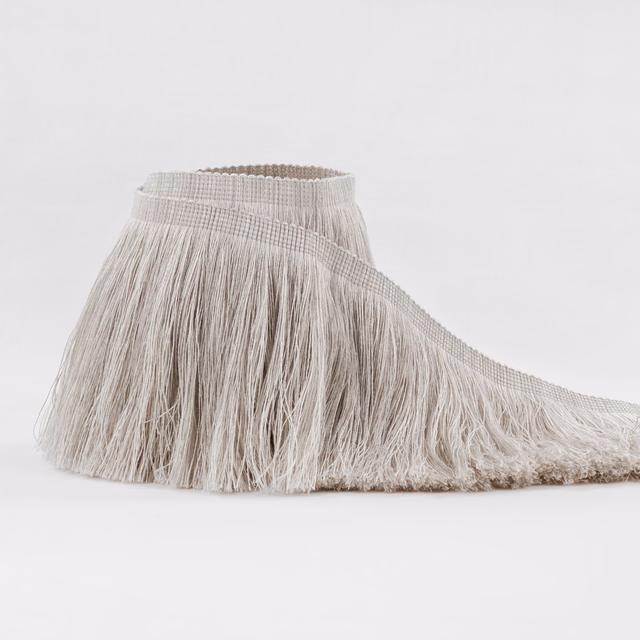Pale silvery-greige fringe with ridged header and long loose textured strands