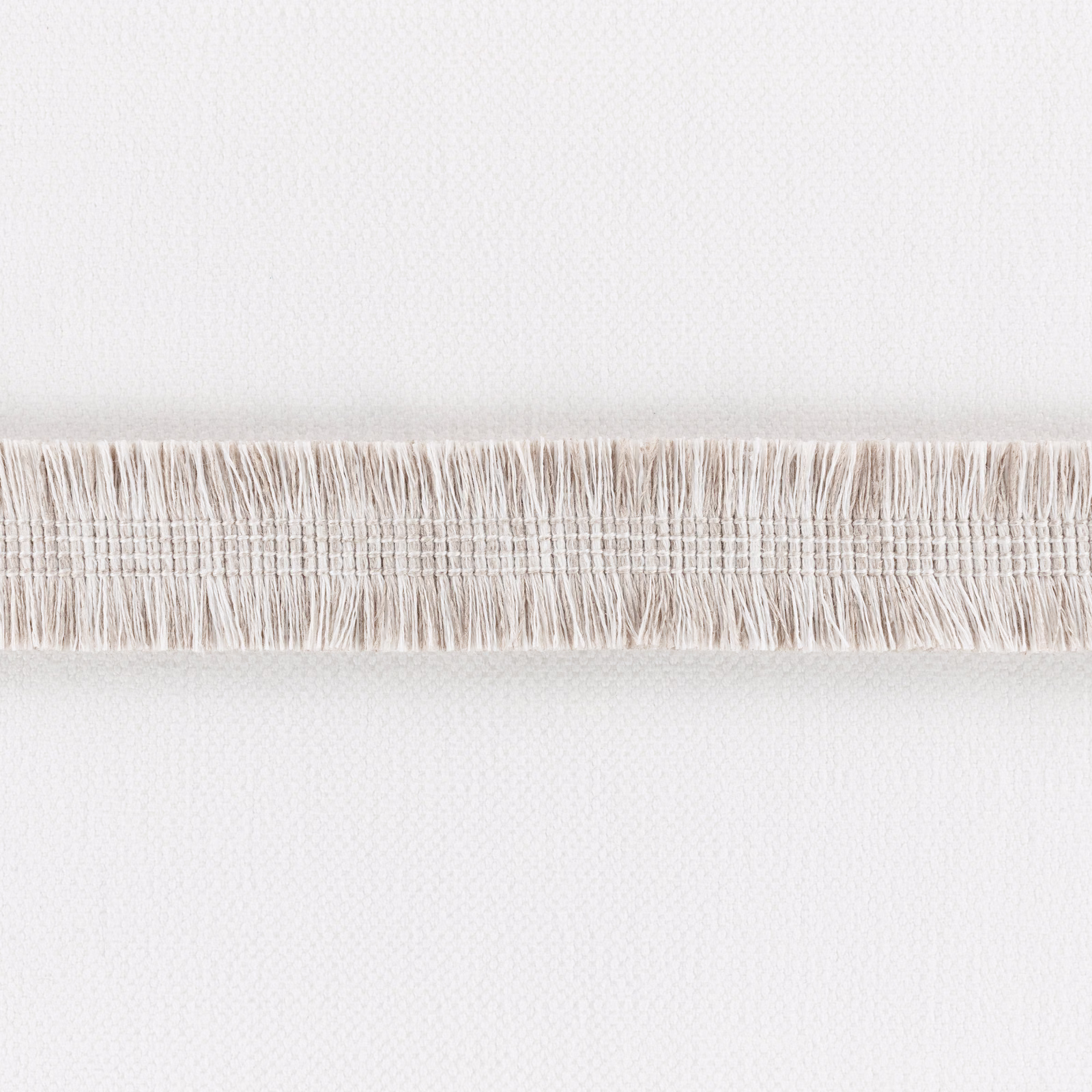 Pale ecru woven fabric with a horizontal band of fine loose fringe