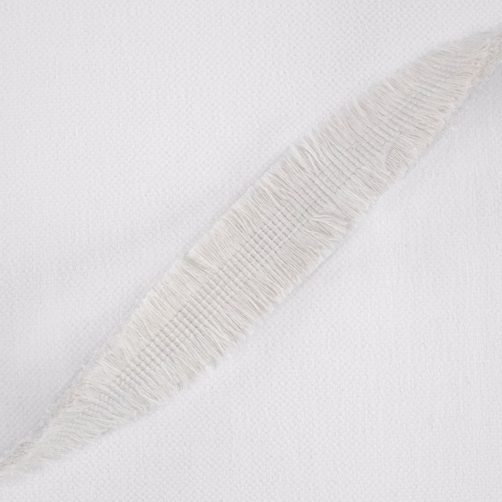 Ivory-white woven fabric with a raised diagonal feather-like motif and fine texture