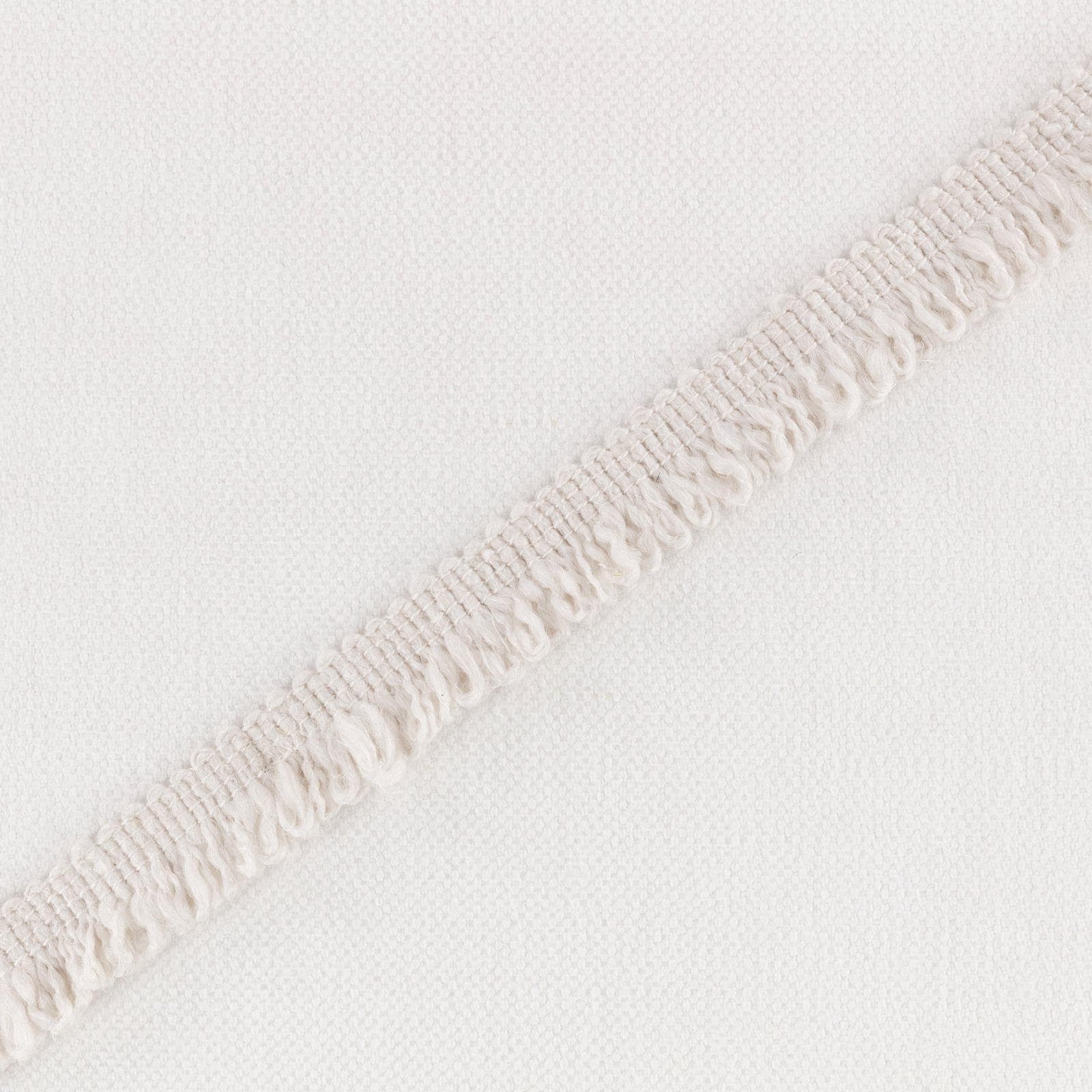 Ivory woven ground with a raised, looped diagonal stripe in close view