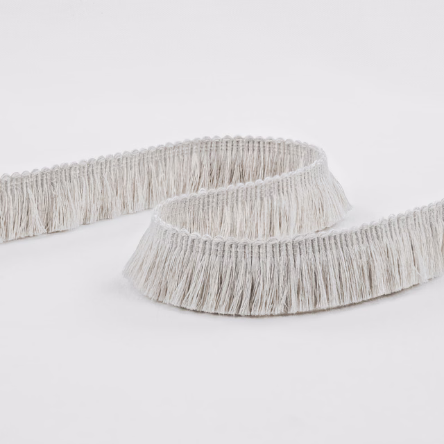 Pale silver-grey fringe with long brushed threads arranged in a curved loop