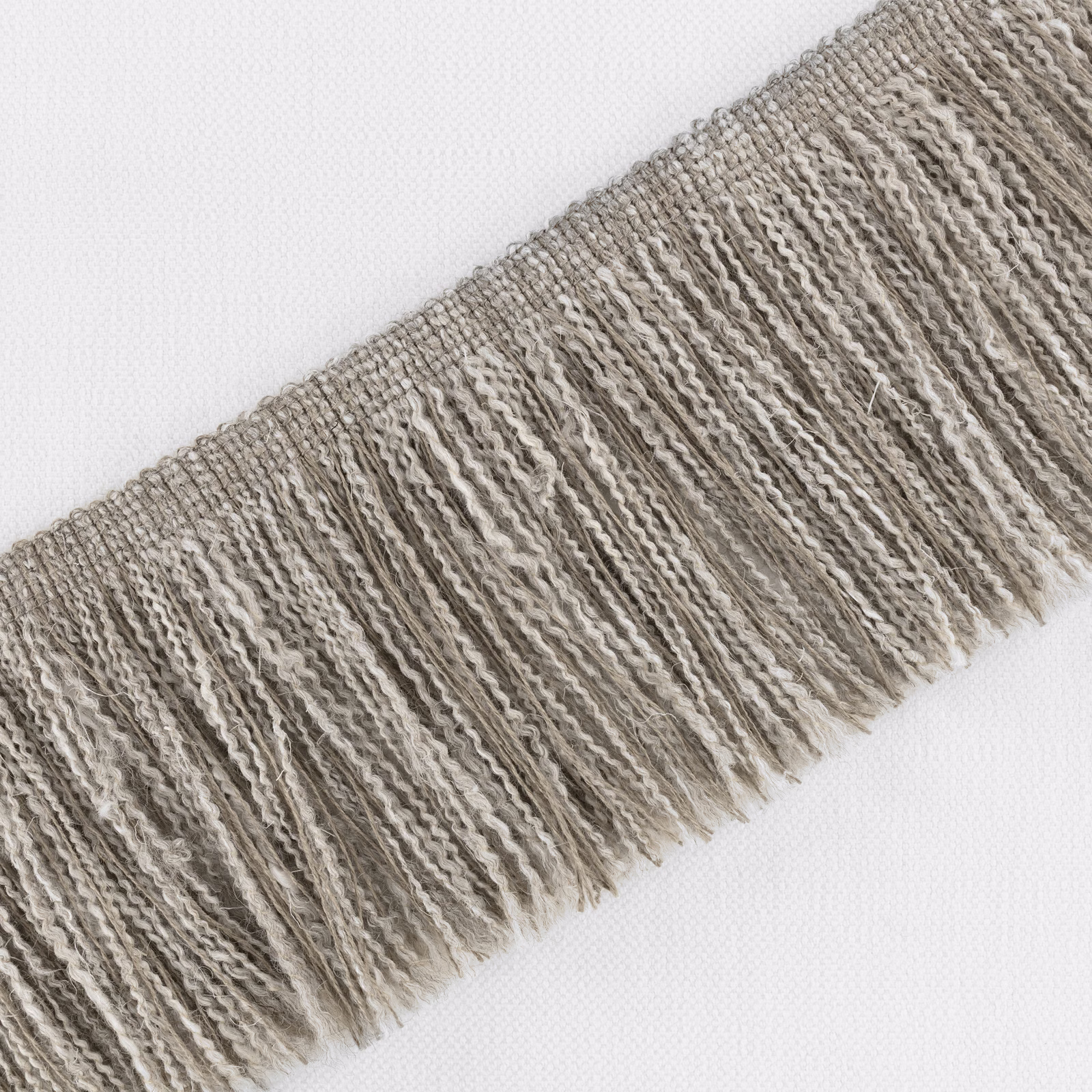 Cool cement taupe fabric with irregular raised ribs and a softly fringed edge