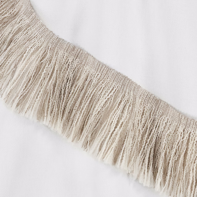 Warm beige woven fringe with long irregular tassels and open textured band
