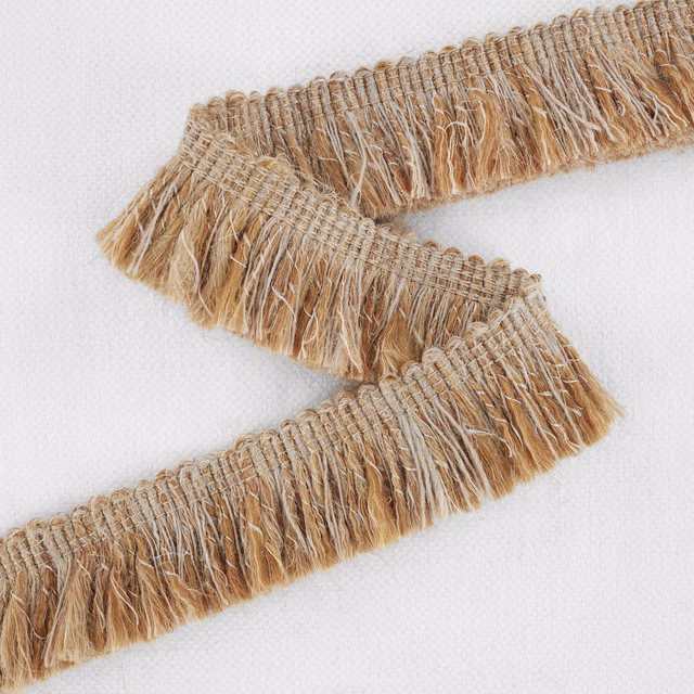 Warm beige woven fringe with cream, tan and caramel fibres in close view