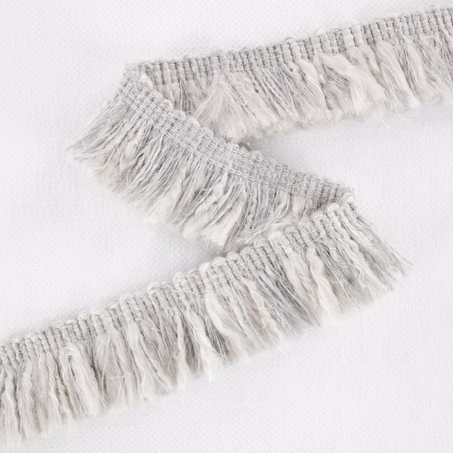 Pale silver-grey woven textile with wispy layered fringe and soft tonal variation