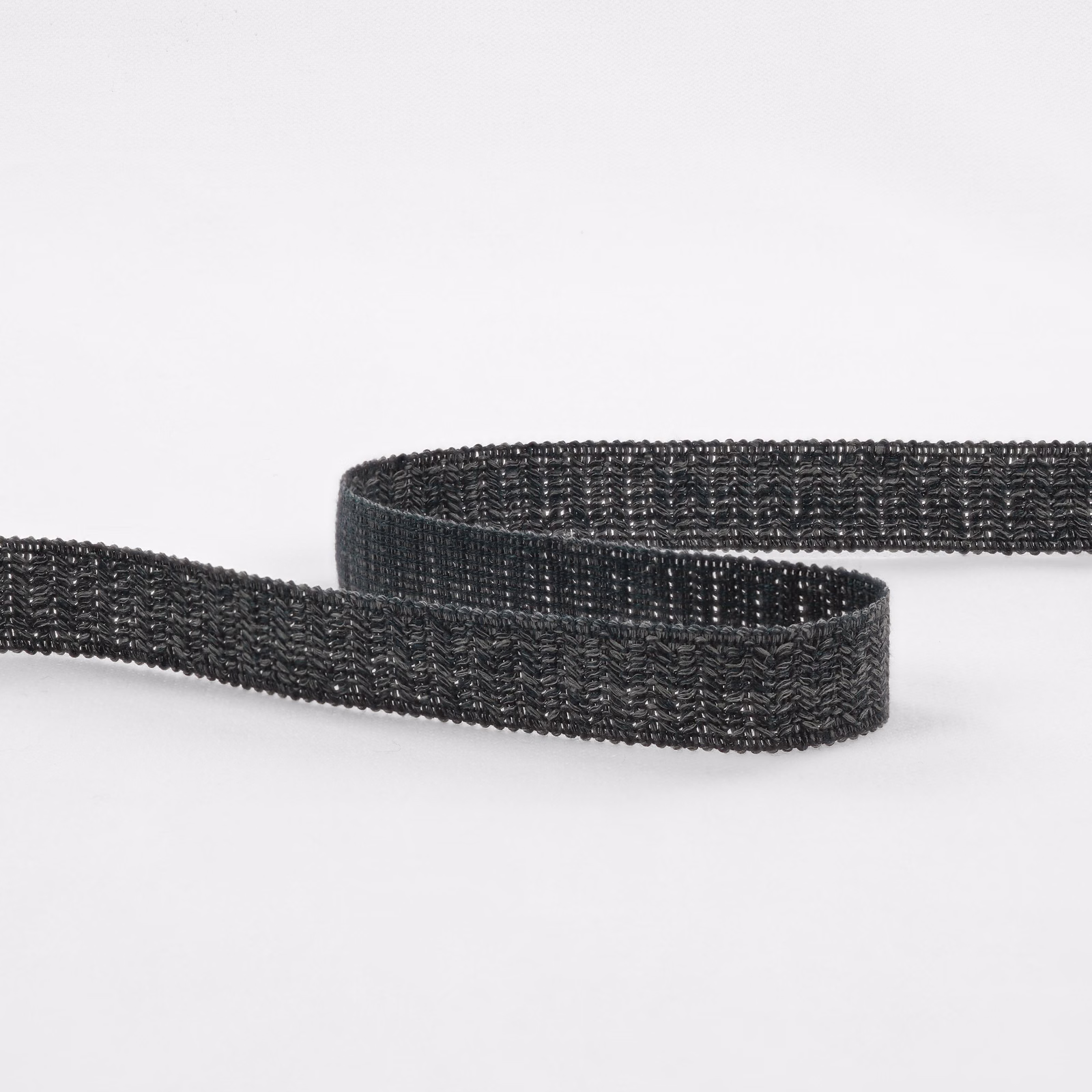 Deep charcoal-indigo woven textile strip with raised repeating texture and subtle blue highlights