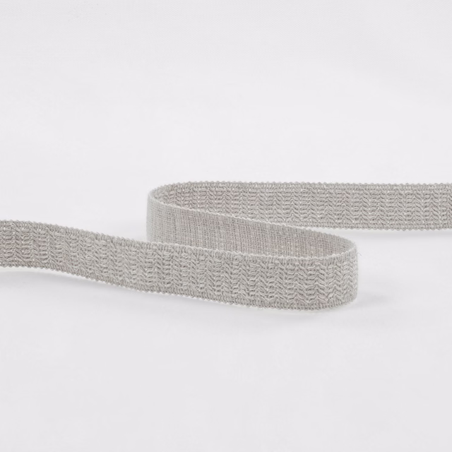 Pale silvery-grey woven textile with a fine chevron texture on a curved strip