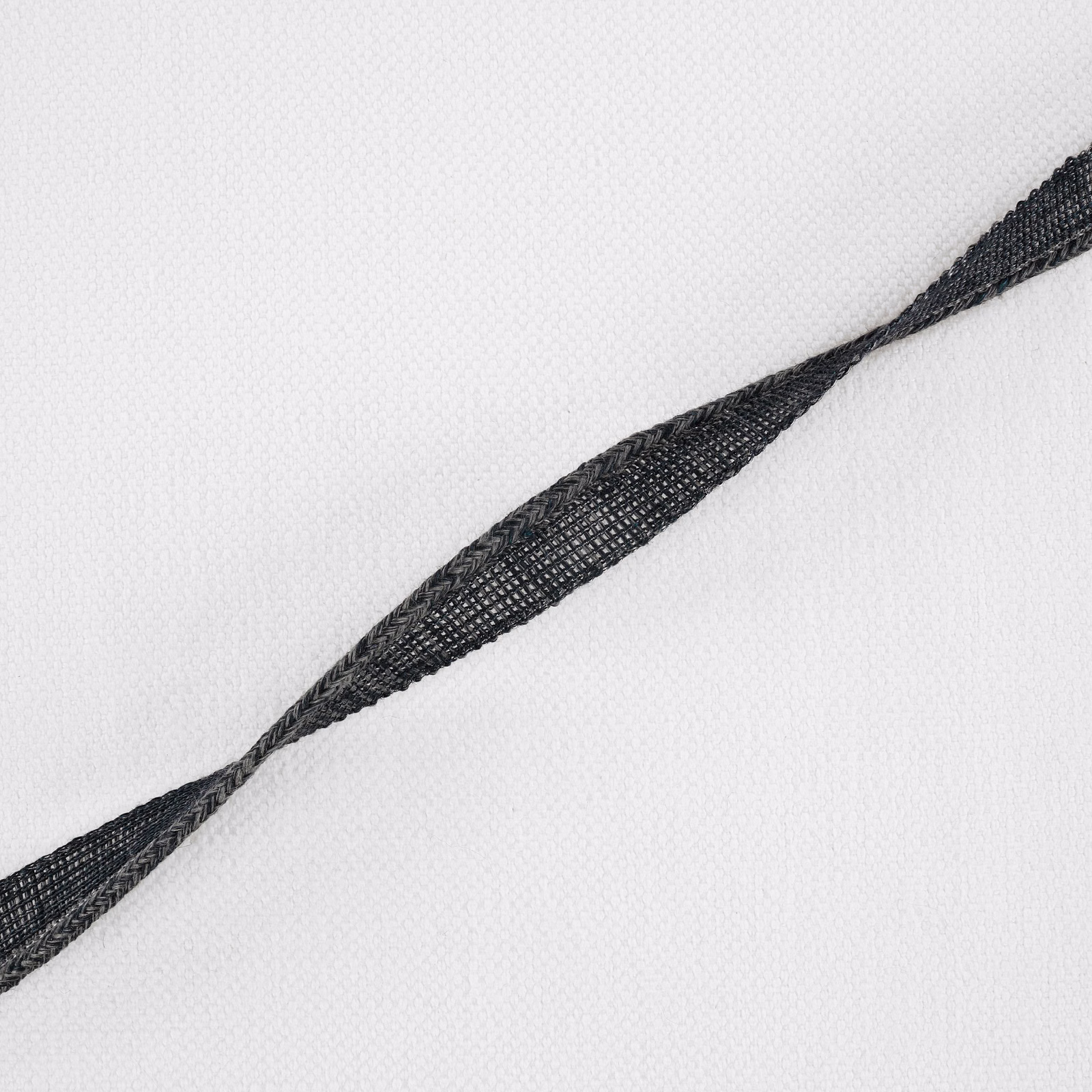 White woven fabric with a dark indigo twisted linear motif