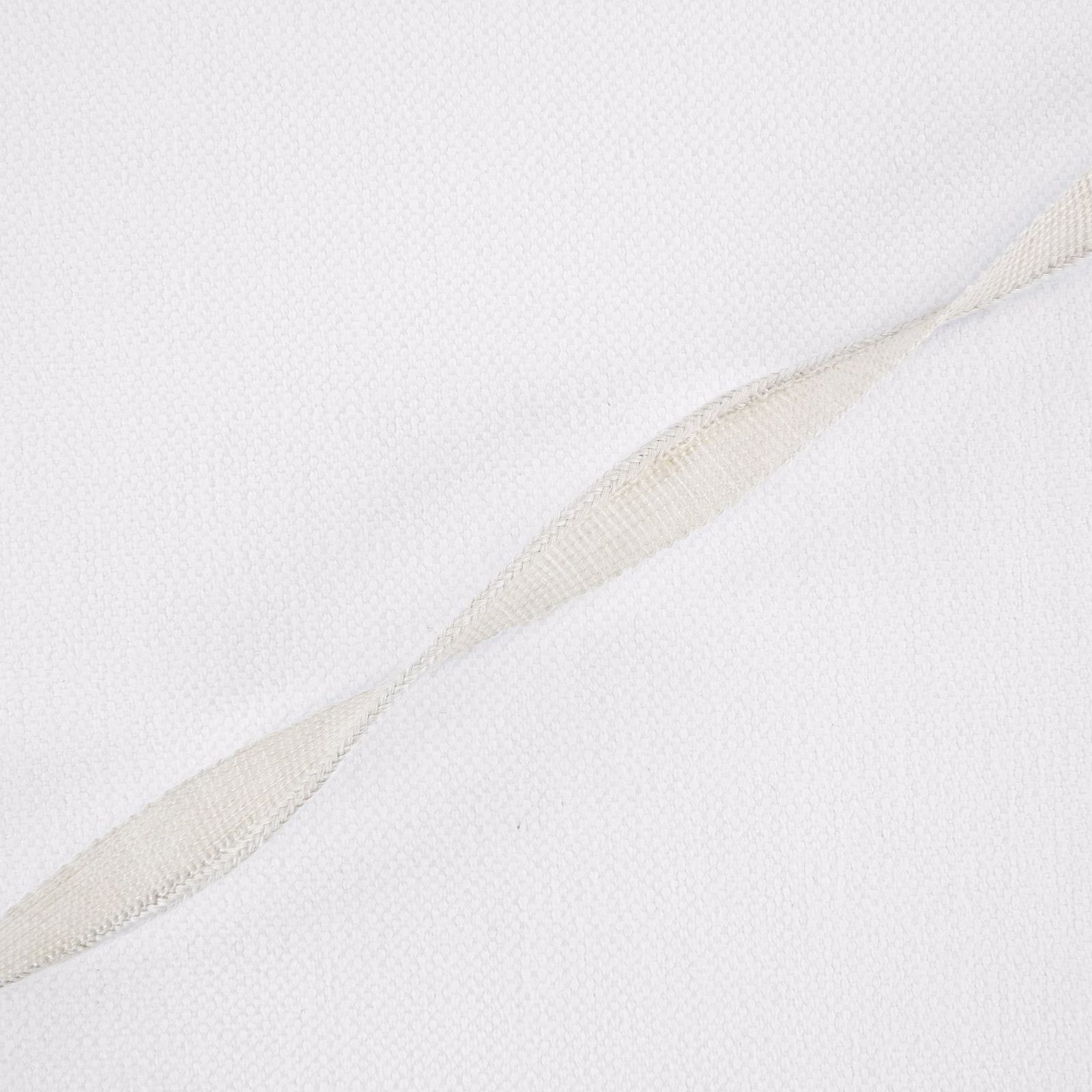 Near-white fine weave with a warm ivory diagonal raised band