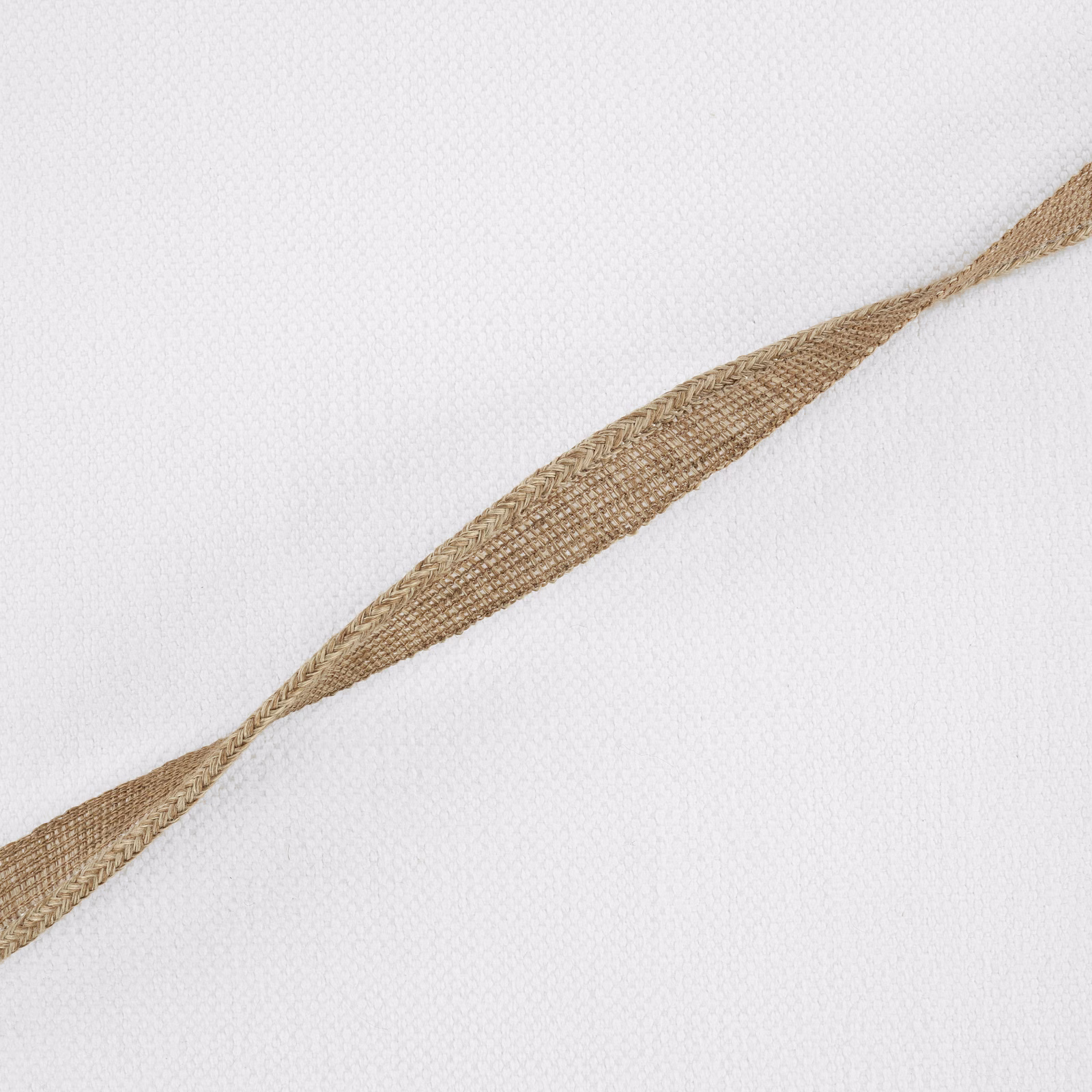 Ivory woven fabric with a warm sand-brown pointed diagonal motif