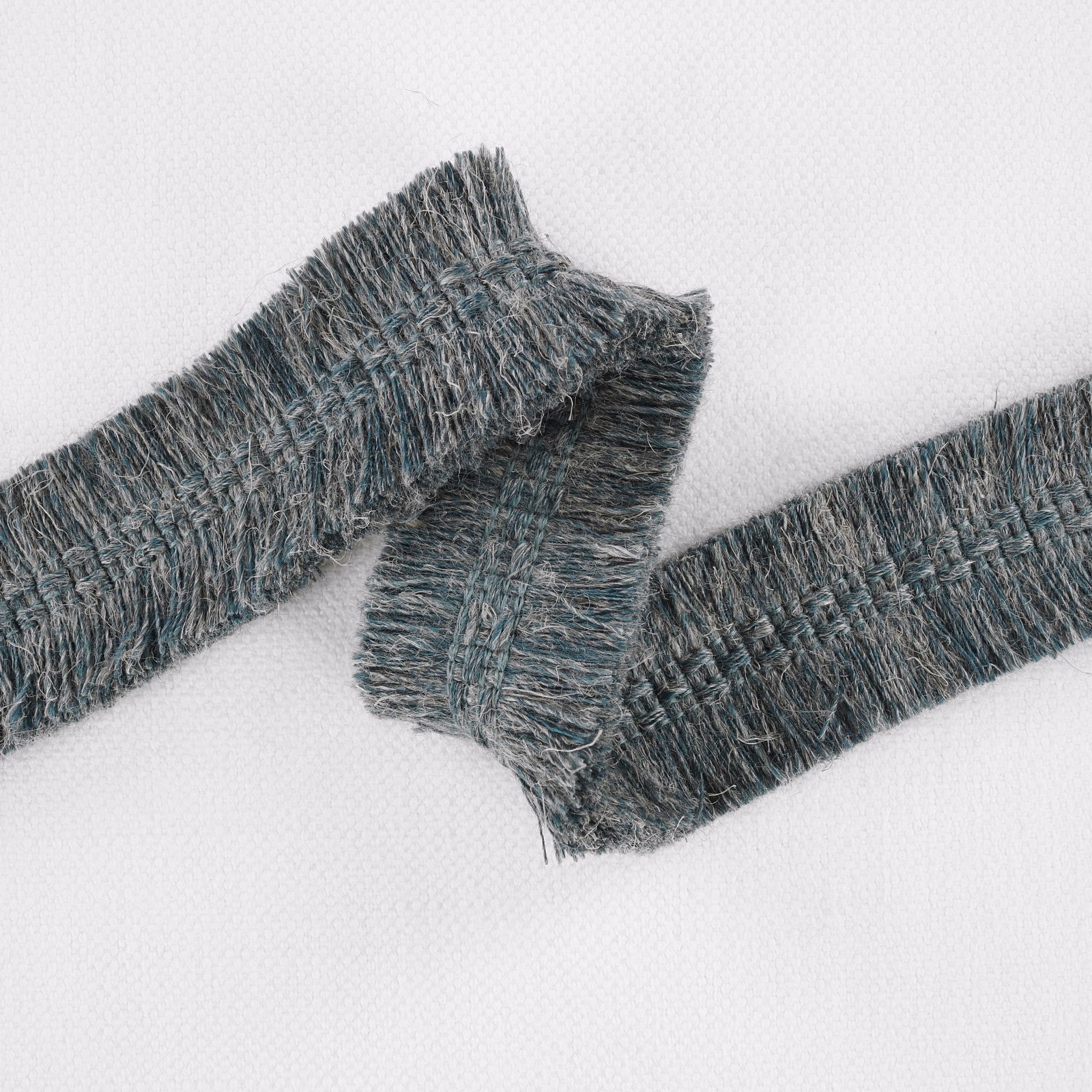 Deep peacock teal textured fabric with raised blue-grey yarns and a shaggy woven surface