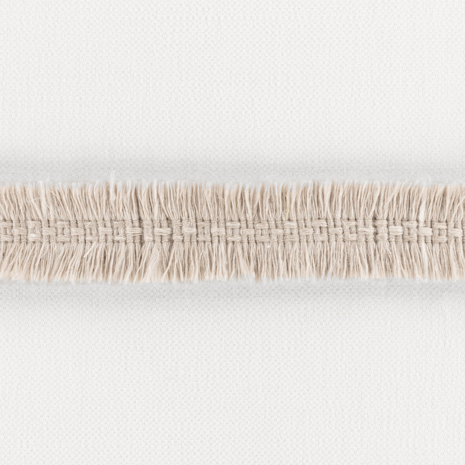 Pale plaster ivory woven textile with a horizontal cream fringe band