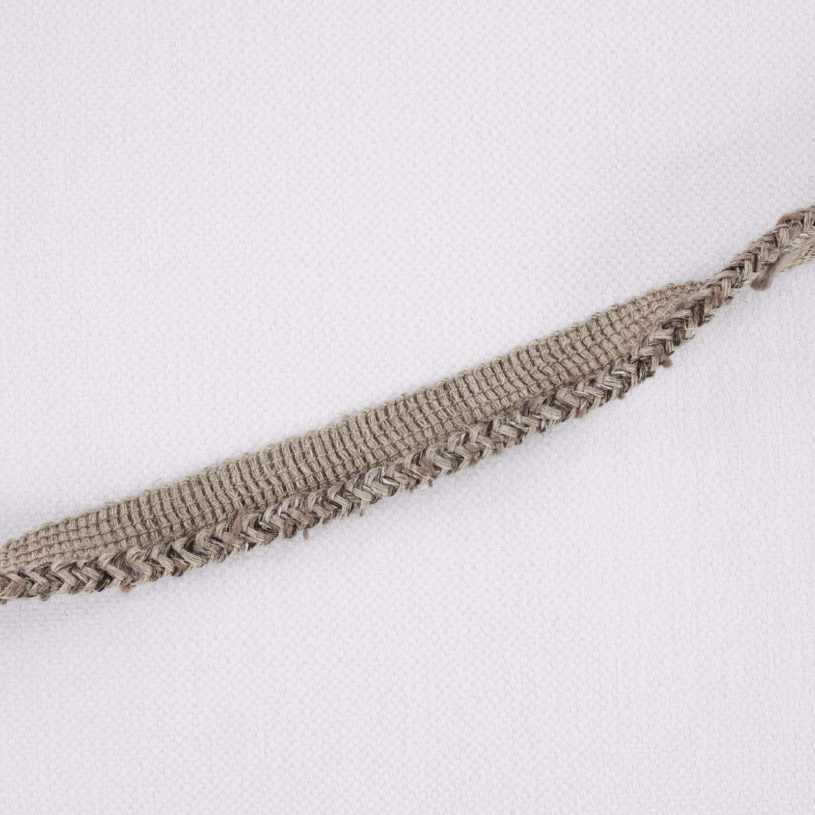 Taupe-grey woven fabric with a raised braided band on an ivory ground