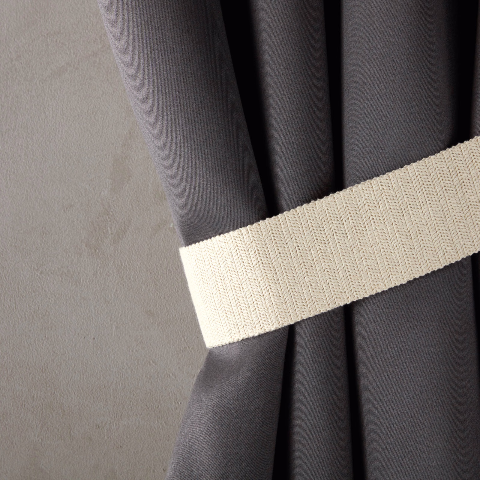 Ivory cream herringbone weave band crossing charcoal drapery