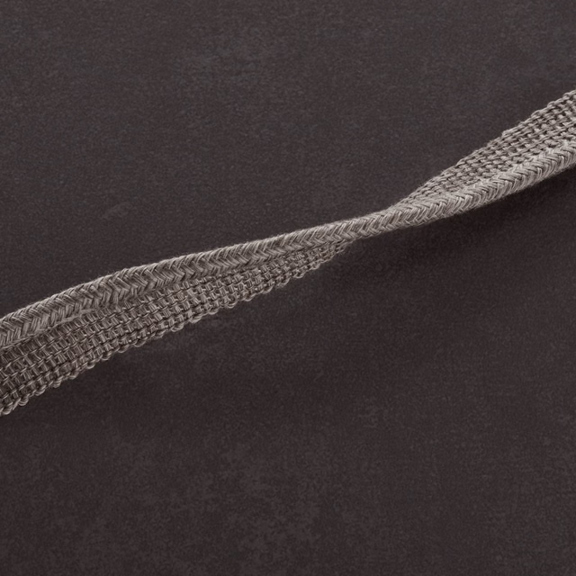 Charcoal-grey textile with softly mottled ground and raised diagonal braided detail