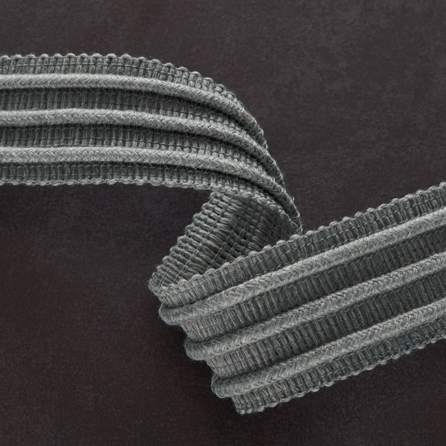 Deep charcoal grey textile with raised ribbed cords and lighter woven edges