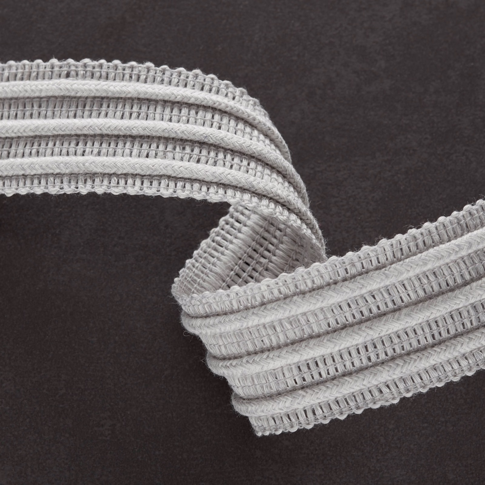 Soft grey woven fabric with raised horizontal ribs and looped edging
