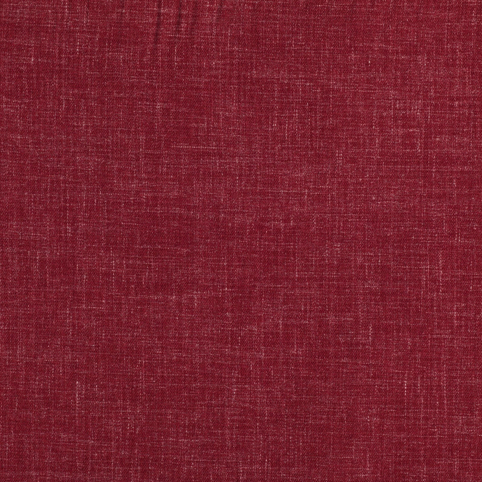 Close-up of warm cinnabar red fabric with a fine irregular slub weave texture