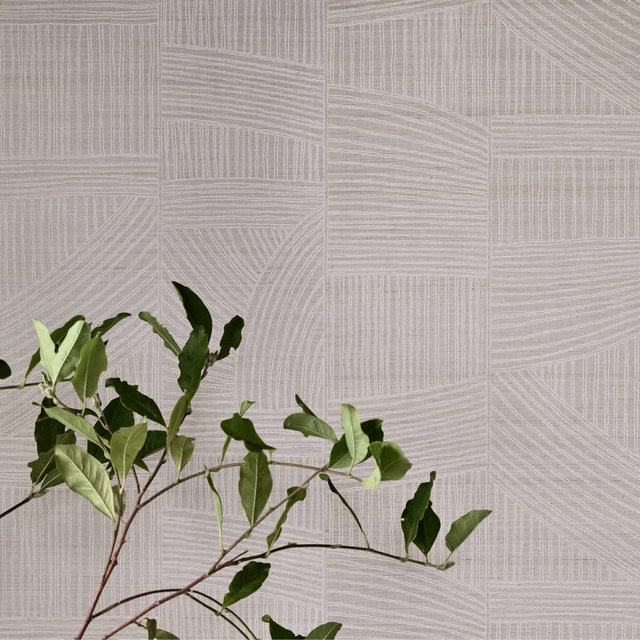Pale powder-grey wallpaper with fine directional lines forming geometric panels